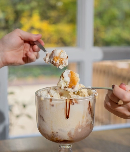 A served Baileys Caramel Profiterole sharer being enjoyed by customers at a Hungry Horse venue.
