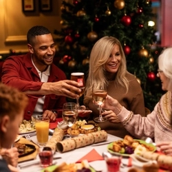 A family cheersing over Christmas dinner.