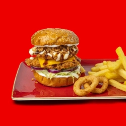 The Hungry Horse Smoky Rancher Burger served on a red plate with fries and onion rings; on a bright red background.