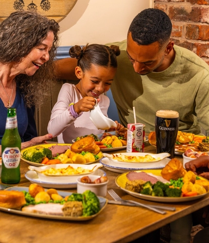 Family sharing pub meals around a table.