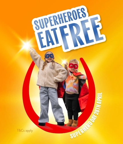 Two children in superhero costumes stand inside a red horseshoe graphic with text that reads “Superheroes Eat Free” and “Superhero Day 28th April” on a bright orange background for Hungry Horse venues.