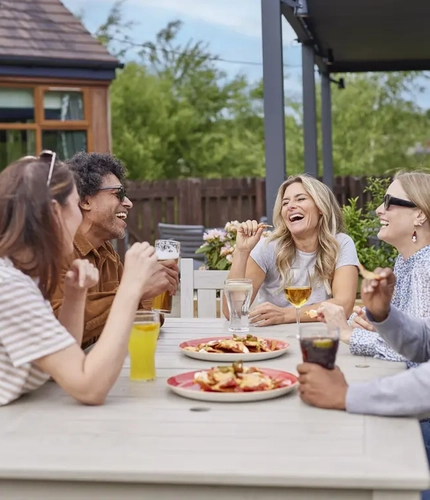 Guests enjoying drinks together in a pub beer garden.