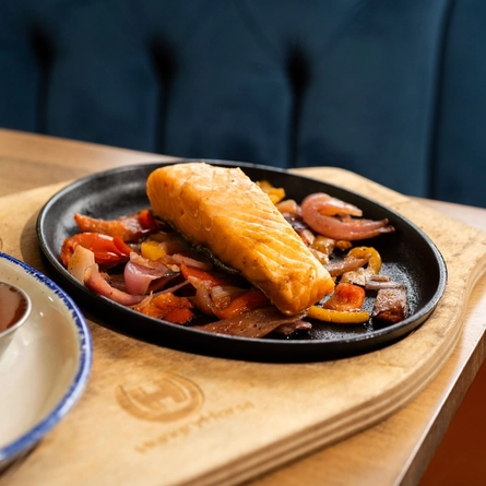 A served main of salmon sizzler available at Hungry Horse venues.